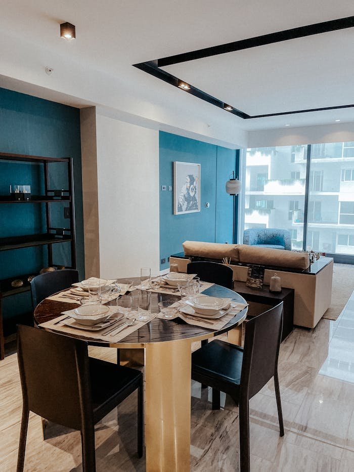 Stylish modern apartment interior featuring a dining setup and living space.